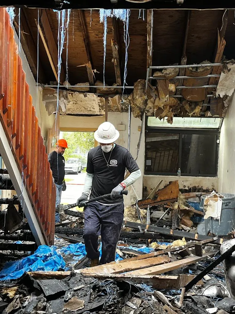 ITD Restoration crew clearing fire debris in PPE