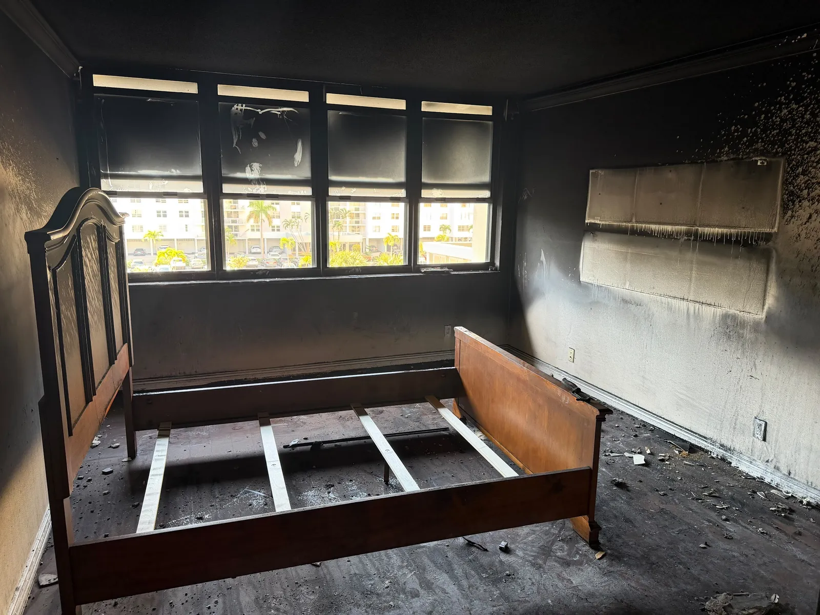 Bedroom with fire and smoke damage to walls and ceiling