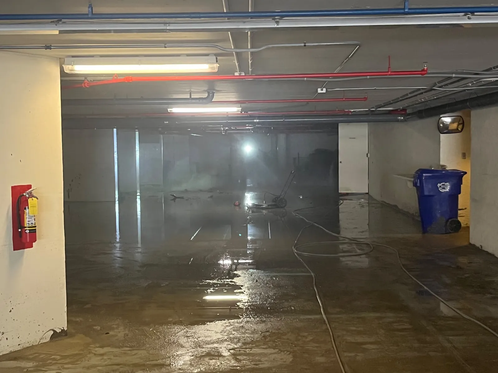 Flooded garage corridor during cleanup