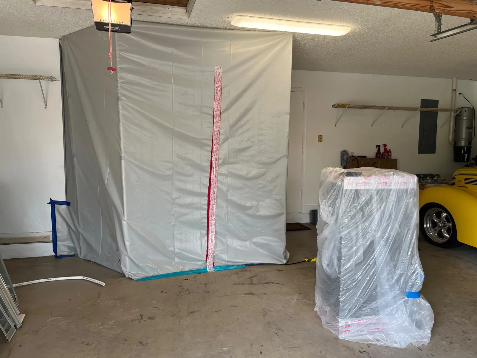 Mold containment tent set up in a garage