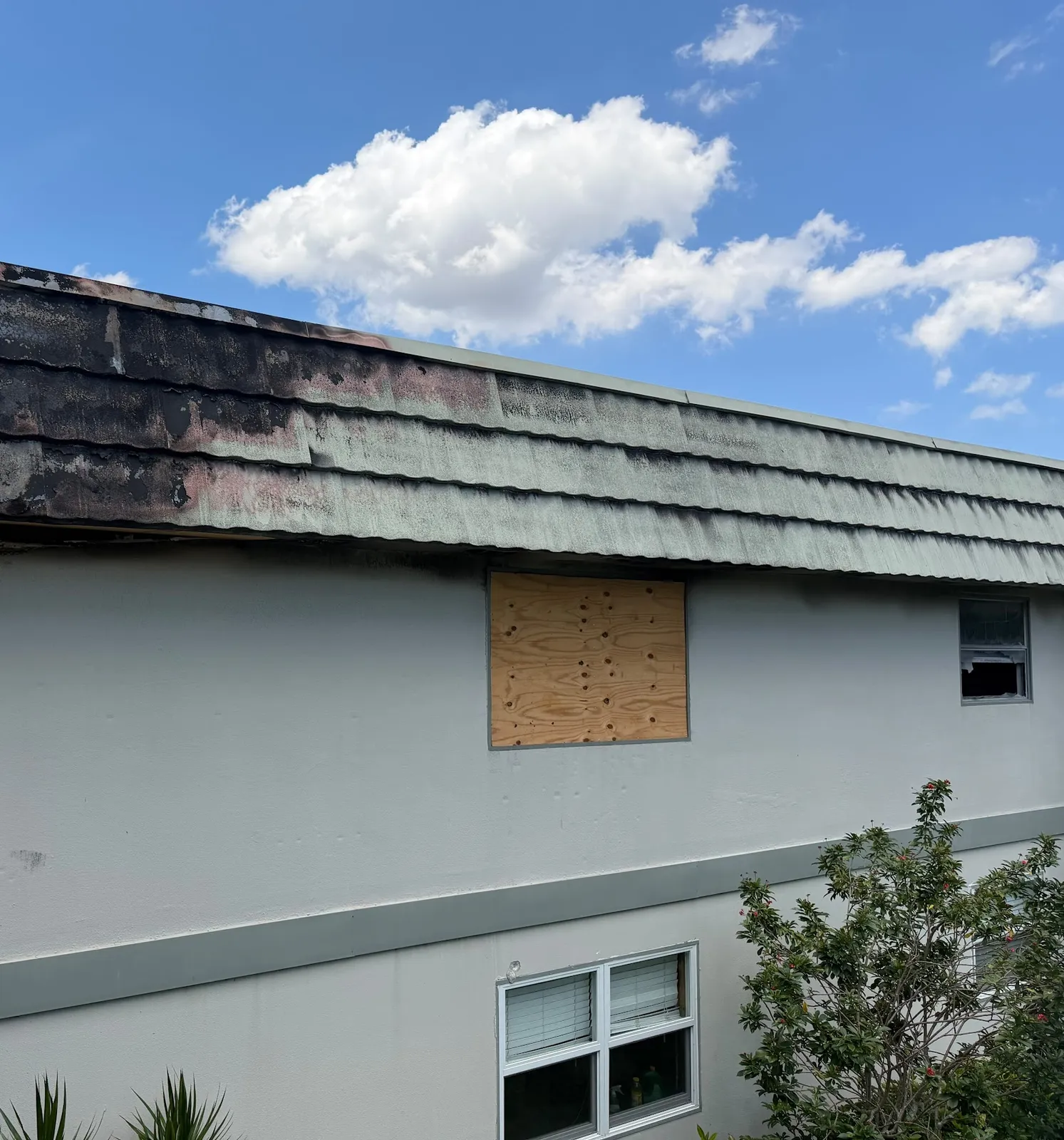 Storm damaged tile roof with burned eave