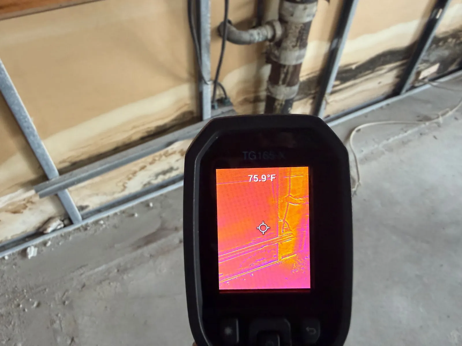 Thermal camera showing moisture at the base of a wall