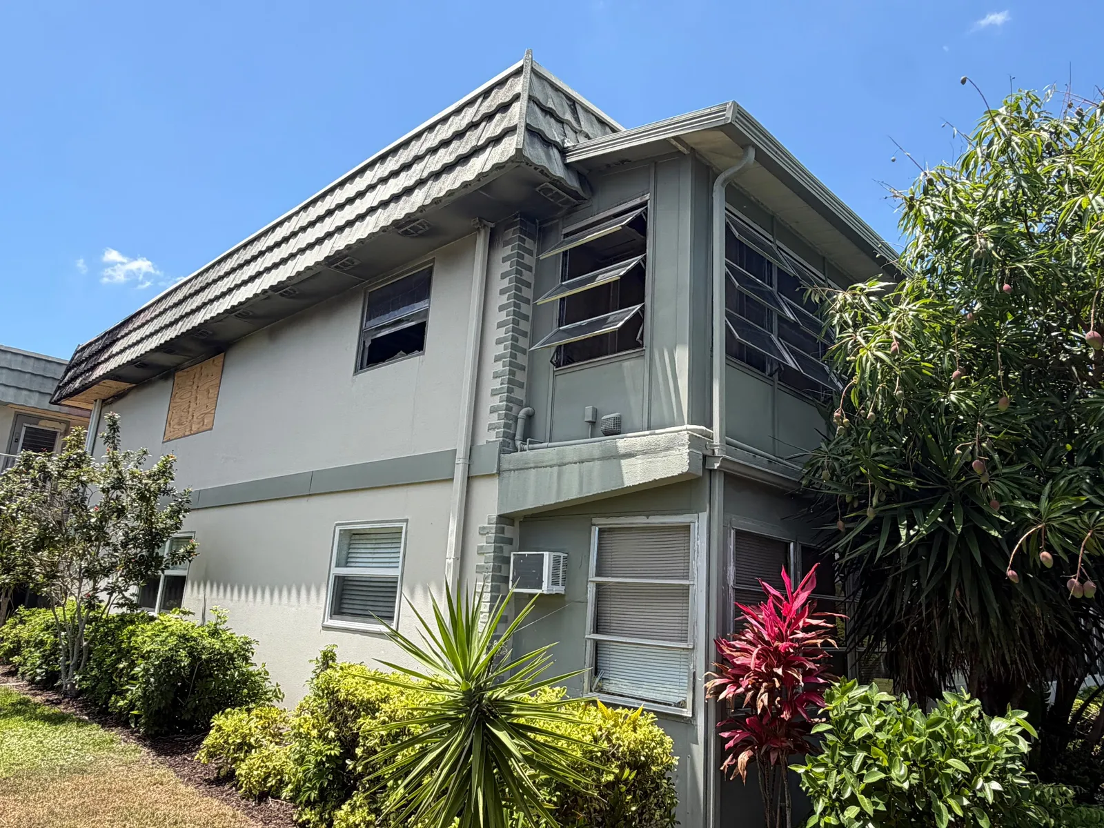 Two storey building with damaged tile roof