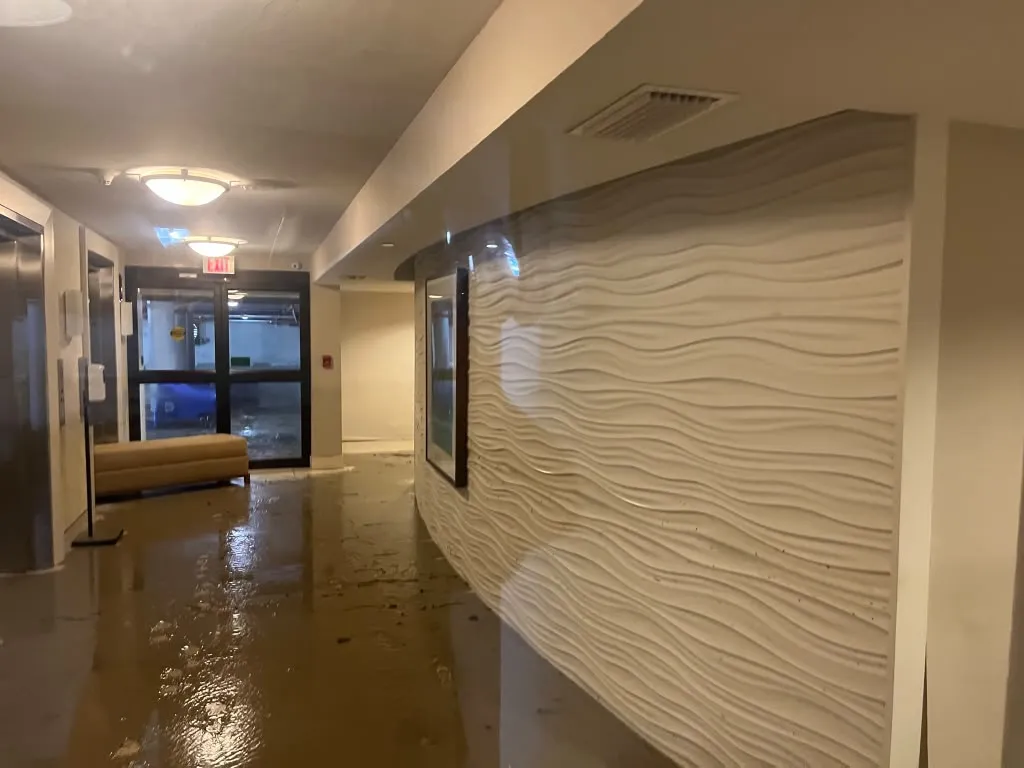 Water damaged commercial hallway with standing water