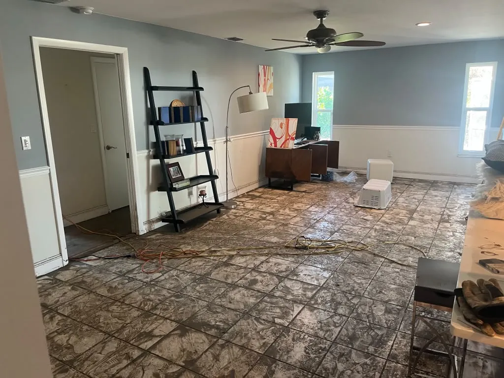 Living room water damage with staining on flooring
